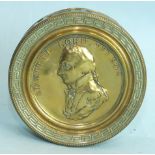 A 19th century circular brass snuff box, the lid with embossed profile of Admiral Lord Nelson,