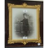 A Victorian photograph on white ceramic plaque depicting a young boy in clan tartan, within a gilt