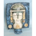 A Troika Pottery mask, marked 'A B',  painted in shades of blue and green, 26cm high, (small chip to