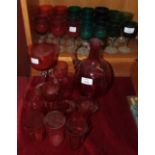 A collection of cranberry glass including a decanter, (stopper lacking), seven wine glasses, seven