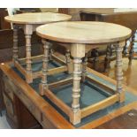 A pair of oak circular-top occasional tables on ring-turned legs united by stretchers, both 58cm