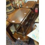 A low stained oak double-drop-leaf coffee table on turned supports united by stretchers, 120 x