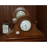 A brass carriage timepiece with white enamel dial, 13cm high overall and two inlaid wooden mantel