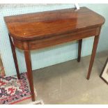 An early-19th century inlaid mahogany fold-over card table