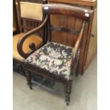 An early-Victorian mahogany carver chair with drop-in seat and turned front legs.