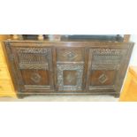 An antique carved oak dresser base having a drawer and three cupboard doors, 175 x 92cm.