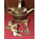 A gilt metal cherub hanging light fitting and a brass water can, 29cm high, (2).