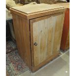 A stripped pine low rectangular single-door cupboard, 65cm wide, 94cm high.