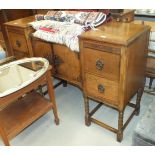 A mid-20th century oak sideboard, the rectangular top above a pair of central doors flanked by