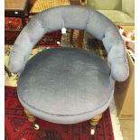 A late-19th century upholstered low-back nursing chair