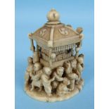 A Japanese ivory okimono of a crowd of people carrying a small ceremonial room on their shoulders,