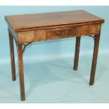 A George III mahogany tea table, the fold-over rectangular top above a small frieze drawer, on