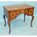 A walnut knee-hole dressing table of early 18th century style, the rectangular top and three small