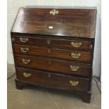 An 18th century country-made oak bureau with rustic fitted interior above four graduated drawers, on