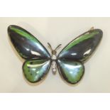 A large belt plaque in the form of a butterfly, each glazed wing containing a black and green