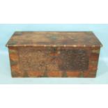 A colonial metal-bound hardwood chest with foliate carved front, pierced brass corners and