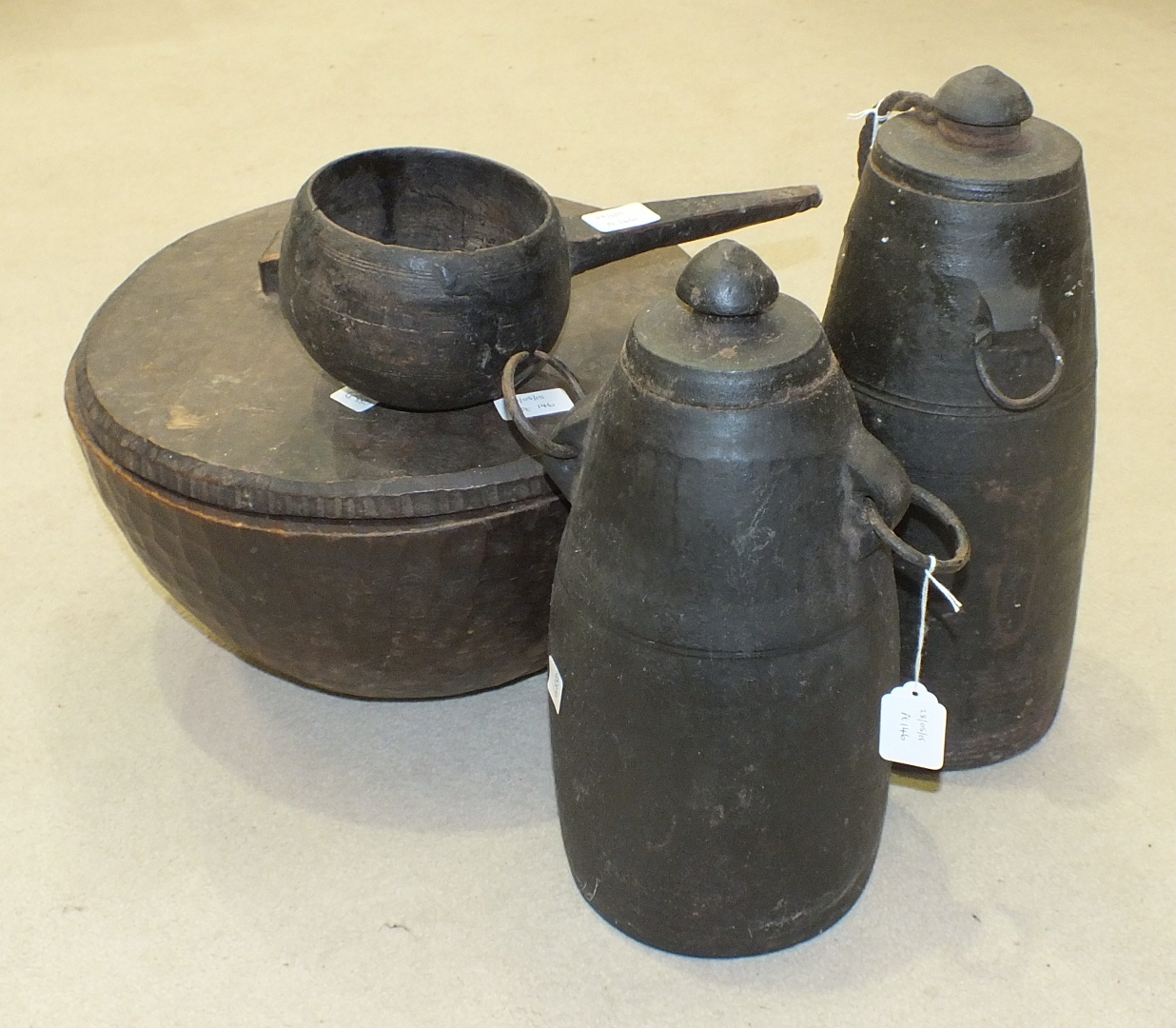 Two Eastern turned wood food bowls with metal carrying handles, 77cm diameter and 49cm diameter