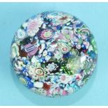 A small 19th century French 'scrambled' millefiori paperweight, scratched, 5.4cm diameter.