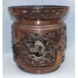 A 19th century Chinese bronze and brass pierced lamp shade of cylindrical shape, decorated with a