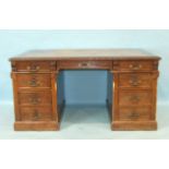 A late Victorian oak kneehole partners desk, the rectangular top inset with writing surface above