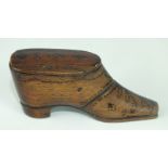 A 19th century mahogany snuff box in the form of a shoe with sliding lid and stud work decoration,