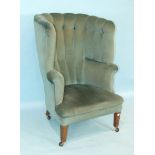 A Georgian-style tub armchair, the high upholstered back and seat raised on square tapered legs.