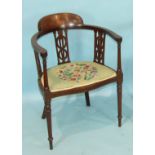 An Edwardian inlaid mahogany corner chair with pierced splats and upholstered serpentine seat, on