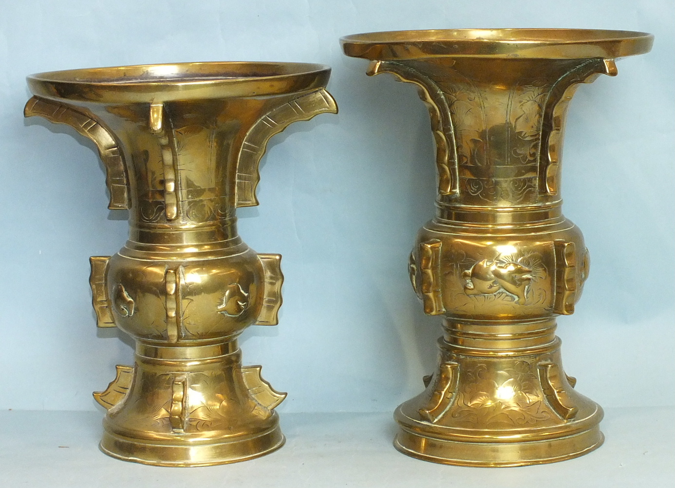 Two 19th century Chinese brass flared vases with engraved decoration, 28cm and 26cm high, (2).