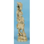 A Japanese ivory figure of a man, a boy on his shoulder carrying a turtle, 26cm.