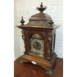 A 19th century German walnut mantel clock with overall gilt metal mounts, on paw front feet with