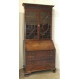 A George III mahogany bureau/bookcase, the upper part with dentil cornice and blind fret frieze