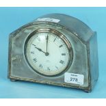 An early-20th century silver-plated mantel clock with circular enamel dial signed 'Payne, Bromley'