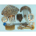 A carved tortoiseshell mantilla comb, a butterfly wing hair ornament and other combs and buckles.