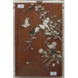 An early-20th century Japanese rosewood rectangular panel decorated with carved ivory birds and