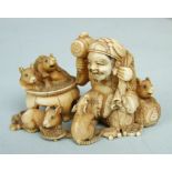 A fine Japanese ivory okimono of a man surrounded by rats, signed, 4cm.