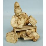 A fine Japanese ivory okimono of a man teaching a monkey to read and write, signed, 9cm high.