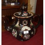 A Measham ware brown earthenware teapot and cover of baluster form, the cover with miniature