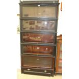 A stained wood five-section Globe Wernicke bookcase, with base drawer beneath each serpentine tier