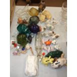 A large collection of glass and ceramic models of pigs, including crested ware and napkin rings.