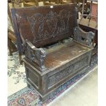 A mid-20th century carved oak monk's bench, 105cm wide.