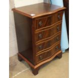 A reproduction mahogany serpentine-front small four-drawer chest, 48cm wide, 71cm high.