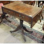 A Georgian-style mahogany drop-leaf side table, the top with reeded edge above two drawers on turned