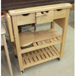 A T&G Woodware white wood food preparation kitchen trolley fitted with three drawers and hinged