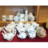 A collection of twelve Victoria and Albert Museum ceramic miniature teapots, commemorative ware