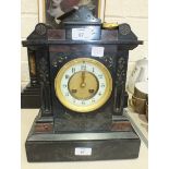 A late-Victorian black slate striking mantel clock of architectural form, 34.5cm high, 27cm wide.