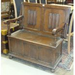 A mid-20th century oak monk's bench, the back with linen-fold decoration, 100cm wide.