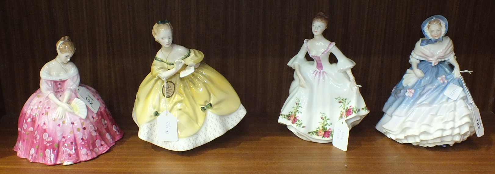 A collection of four Royal Doulton figurines, 'Victoria' HN2471, 'The Last Waltz' HN2315, 'Country