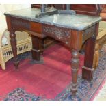 A late-19th century walnut side table, the low shaped back above a marble top and carved frieze,