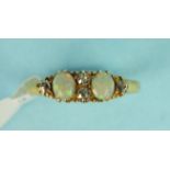 An opal and diamond ring set two opals and four old brilliant cut diamonds in unmarked gold mount,