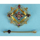 A 9ct gold open work brooch set garnets and seed pearls, 3cm diameter, 3.6g and a 9ct gold garnet